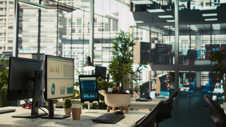 Financial charts and KPI metrics on displays in office